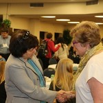 Attendees greet one another